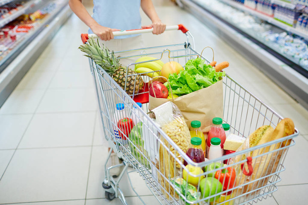 Consumer cart with products  - Фото, зображення
