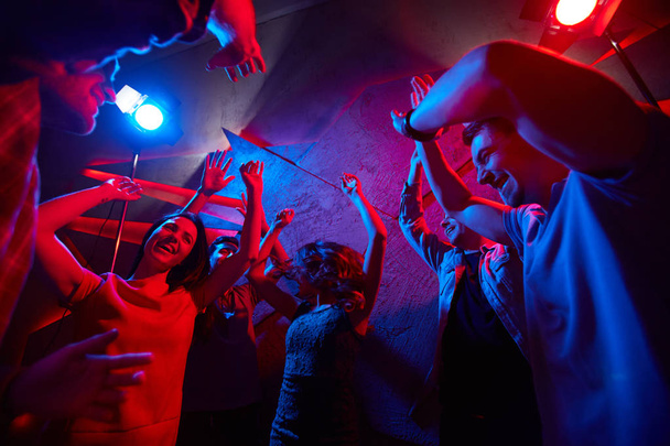 Ecstatic guys and girls dancing at disco - Photo, Image