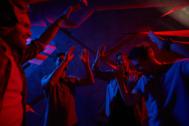 Group of guys dancing in night club  - Фото, зображення
