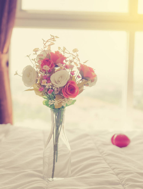Beautiful flower and towels decoration on bedroom - Filter effect - Photo, image