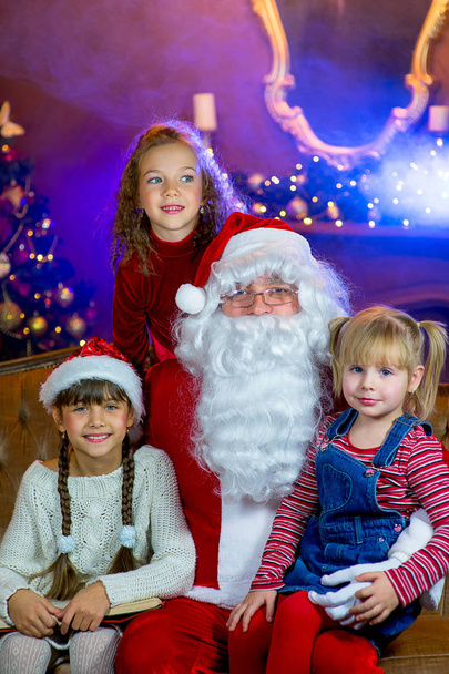 Santa Claus and group of girls reading a book - Photo, Image