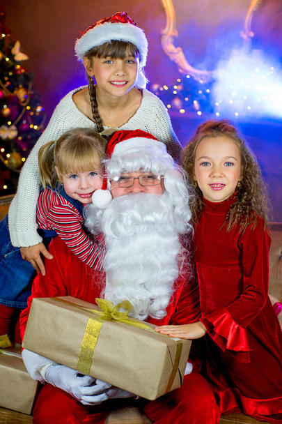 Santa Claus and group of girls with Christmas gifts - Zdjęcie, obraz