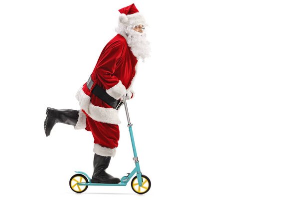 Santa claus riding a scooter - Zdjęcie, obraz