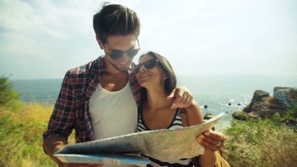 Happy young woman and her attractive boyfriend enjoying good sunny day and planning new destinations. - Footage, Video