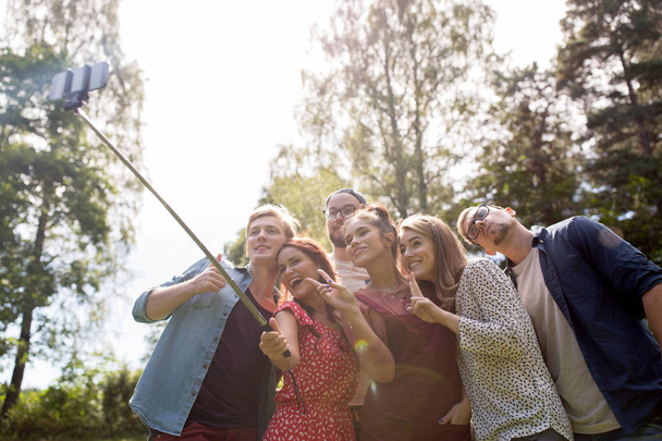 friends taking selfie at party in summer garden - Фото, изображение