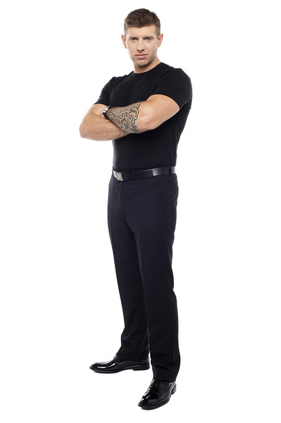 Bouncer with tattoo on hand posing with arms crossed - Foto, Bild