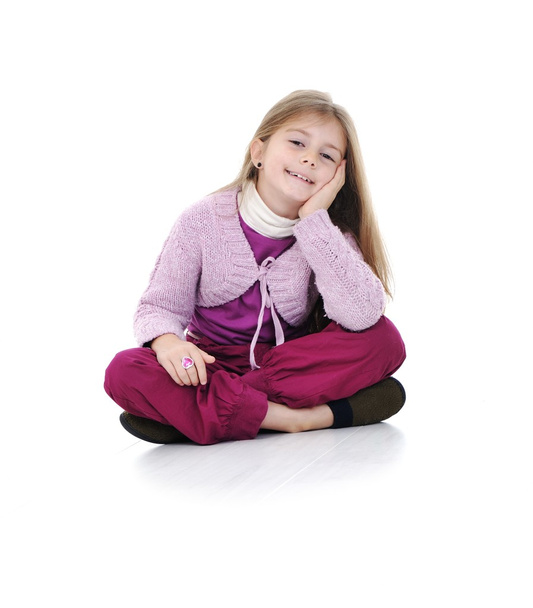 Portrait of a cute little girl sitting on floor - Foto, afbeelding