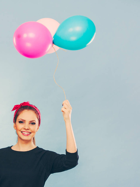 Lovely smiling girl holds colorful balloons. - Zdjęcie, obraz