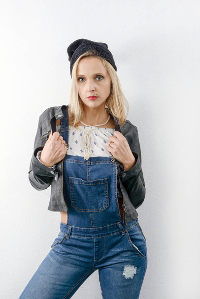 Beautiful young blonde woman with jeans overalls - Fotoğraf, Görsel