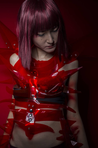 Oriental girl with red plastic costume - Fotoğraf, Görsel