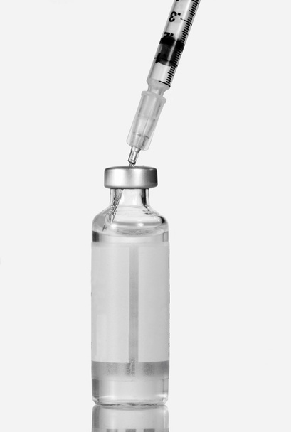 Syringe injected into insulin vial. - Photo, Image