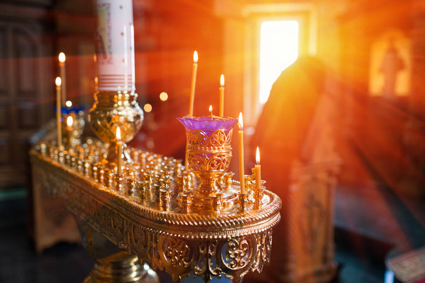 candles and lamp close-up. Interior Of Orthodox Church In Easter. baby christening. Ceremony a in Christian . bathing the into the baptismal font - Photo, Image