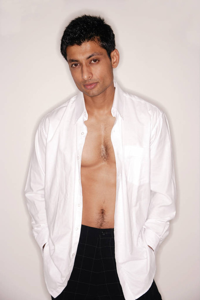 Man looking at camera, shirt fully unbuttoned - Foto, afbeelding