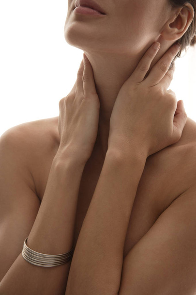 upper body of woman touching her neck - Valokuva, kuva
