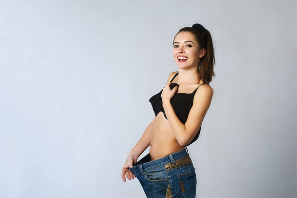beautiful young woman with big jeans weight loss - Photo, Image