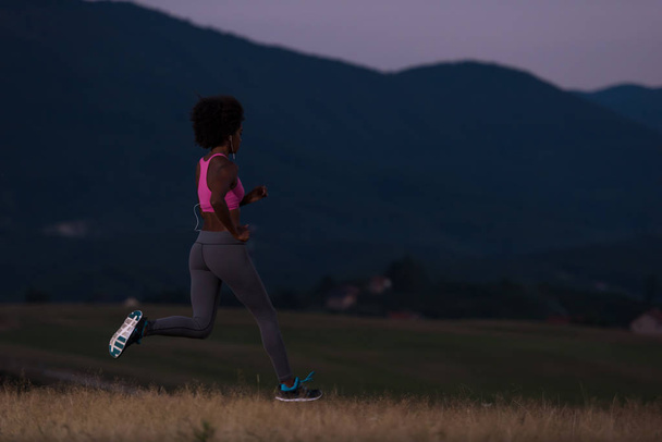 Young African american woman jogging in nature - Foto, Imagem