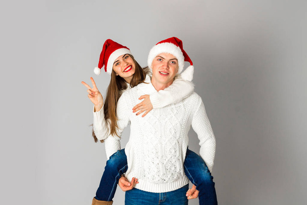 couple in love celebrates christmas in santa hat - Фото, изображение