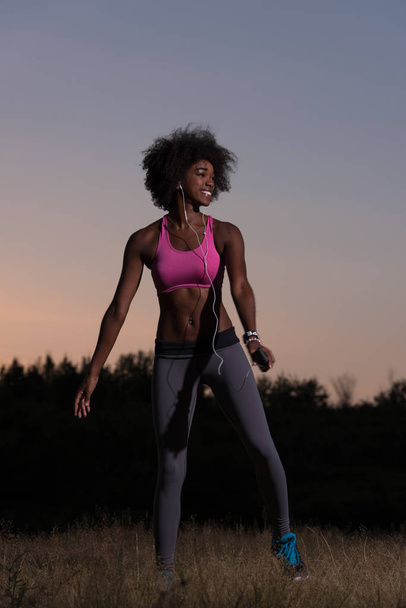 black woman is doing stretching exercise relaxing and warm up - Photo, Image