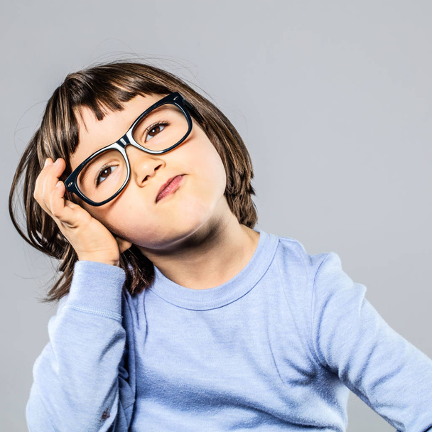 serious preschooler with eyeglasses for thought, imagination, confusion or headache - Φωτογραφία, εικόνα