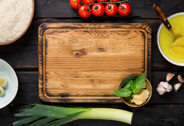 Ingredients for cooking risotto around cutting board - 写真・画像