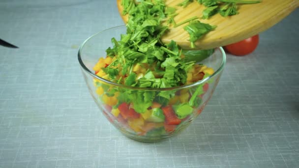 Cook χύνει σε ένα μπολ σαλάτα συστατικά - Πλάνα, βίντεο