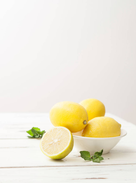 lemons and mint on white wooden table - Photo, Image