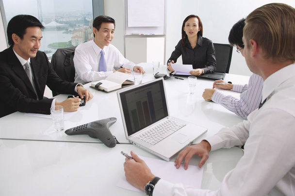 Executives sitting around conference table - Photo, Image