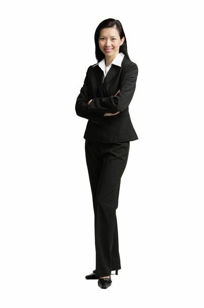 Businesswoman standing with arms crossed - 写真・画像