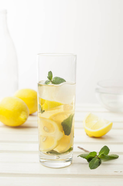 Lemonade with fresh lemon on white - Zdjęcie, obraz