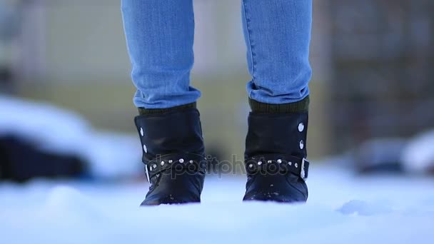 Female feet in black leather winter shoes in snow - Footage, Video