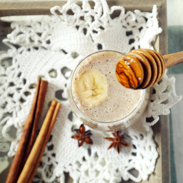 Glass of banana smoothie with cinnamon - Photo, Image