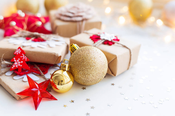 Christmas and New Year background with golden decorative ball, presents and decorations for Christmas tree.  - Foto, immagini