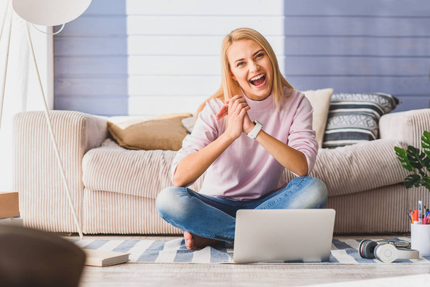 Carefree girl using laptop with joy - Foto, afbeelding