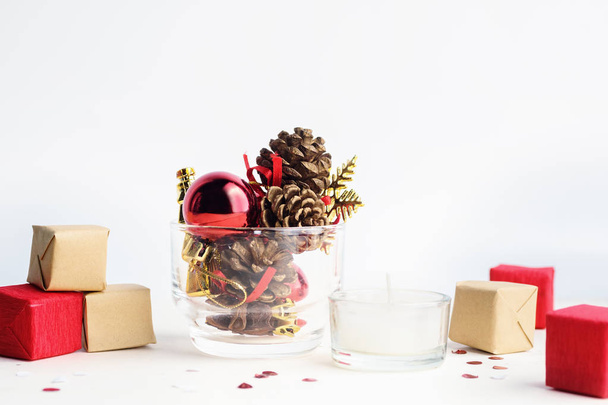 Fir-cones and christmas toys in glass with gift boxes - Valokuva, kuva