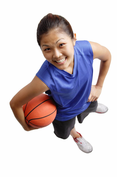 Young woman holding basketball - Foto, Imagen