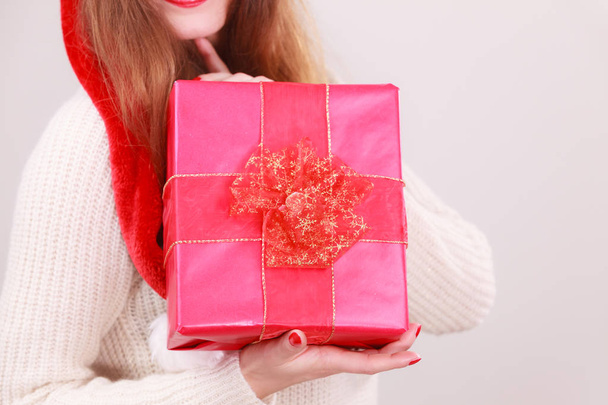 Woman holding gift box. Christmas time - 写真・画像
