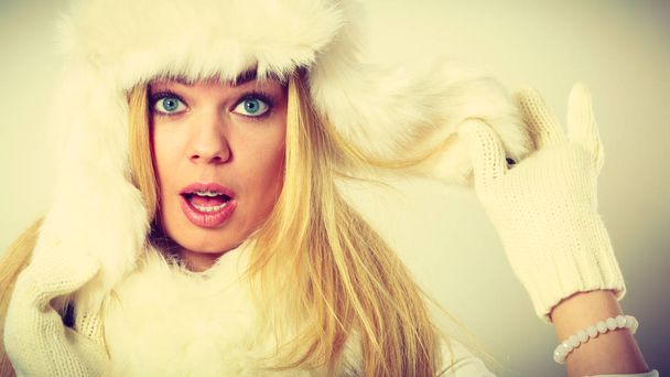 Blonde woman with fur cap. - Фото, изображение