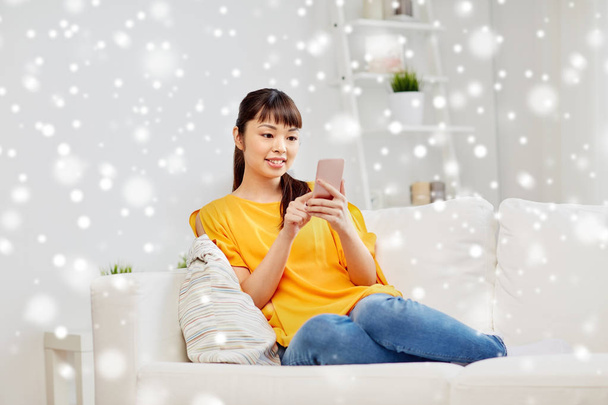 happy asian woman with smartphone at home - Foto, Bild