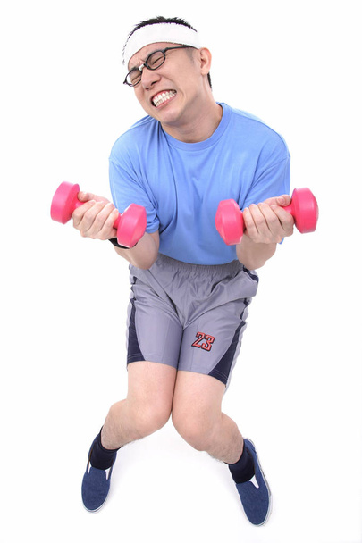 Man with pink dumbbells in hands - Fotó, kép