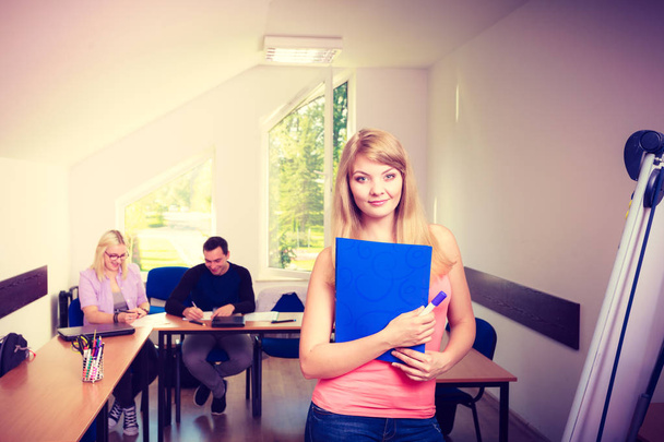 Student girl in front of her mates in classroom - 写真・画像