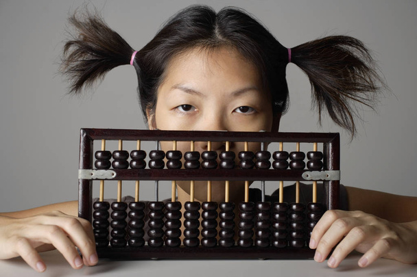 Young woman with abacus. - Φωτογραφία, εικόνα