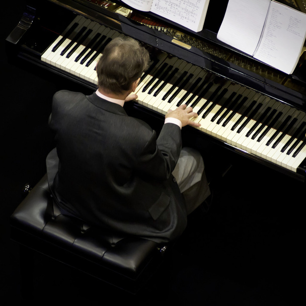 Senior man playing on a grand piano - Photo, Image