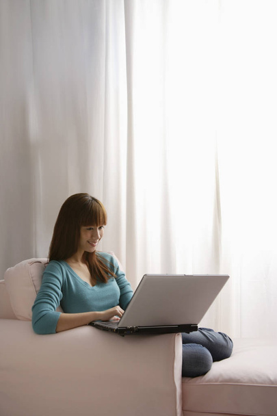 Girl with laptop at home - Photo, Image