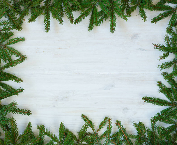 Christmas tree branches on white wooden texture ready for your d - Photo, Image