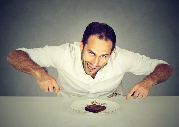 Hungry man craving sweet food pound cake  - Фото, изображение
