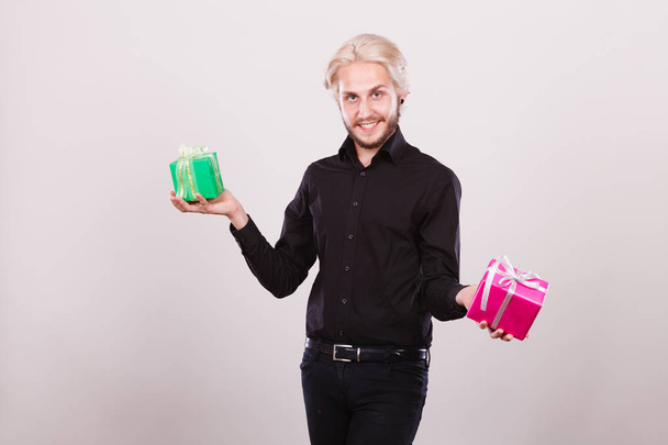 man holding two gift boxes in hands - Photo, image