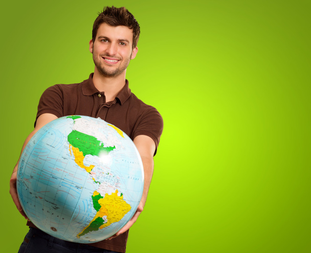 Young Man Holding Globe - Foto, Imagen