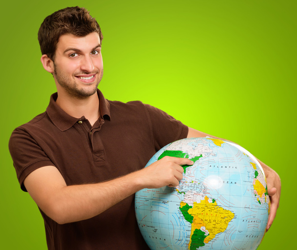 Young Man Holding Globe - Foto, afbeelding