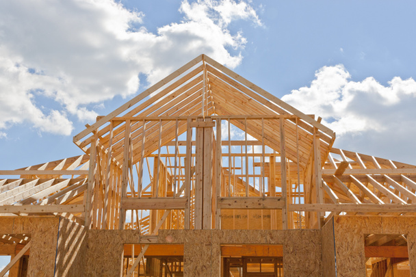 New residential construction home framing against a blue sky - Photo, Image