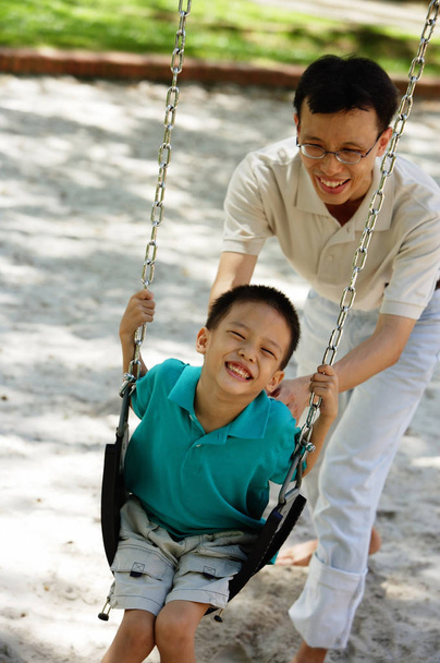 Father and son in playground - 写真・画像
